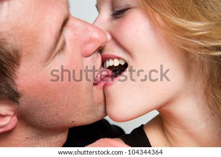 close up portrait of young caucasian couple kissing