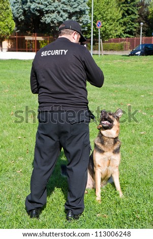 back of a security guard with a dog