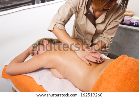 Relaxed woman having a massage in a beauty center