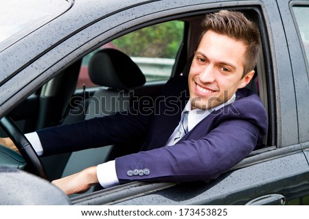 Portrait of an handsome guy driving his car
