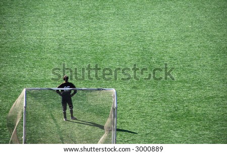 goalkeeper standing in the goalmouth on the football ground