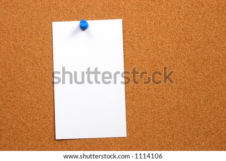 Empty card on a cork board with a small thumb tack and some space on the side for something else