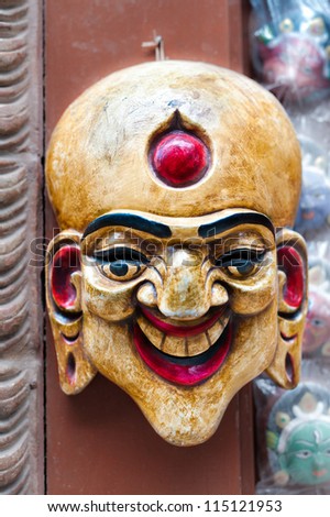 Colorful Buddhist mask on a temple wall