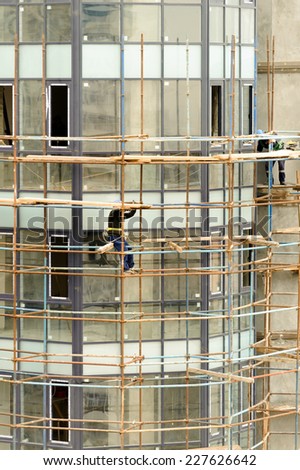 BAKU, AZERBAIJAN - OCTOBER 17, 2014:  construction workers on a scaffold, symbolfoto for building, construction boom, labor protection
