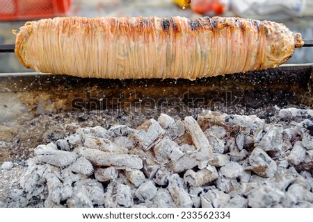 lamb intestine food strapped on skewer, Turkish Kokorec on peddler barbeque in Istanbul, Turkey