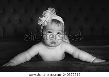 baby girl crying arms open on the bed black and white black white photo