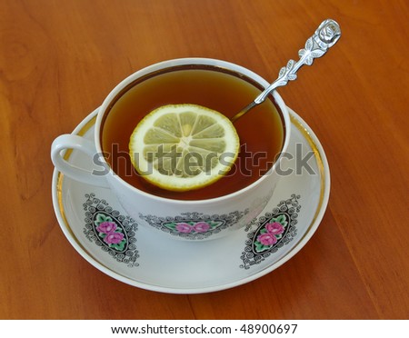 Cup of tea with lemon. See more my photos of cups: http://www.shutterstock.com/sets/66603-cups.html?rid=522649