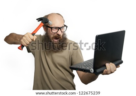 Bearded crazy man with hammer and laptop