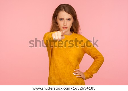 Hey you! Portrait of serious bossy ginger girl in sweater pointing at camera with angry expression and accusing blaming, indicating at you, making choice. studio shot isolated on pink background Stockfoto © 