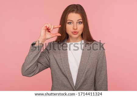 Need some more! Portrait of sceptic displeased young woman in business suit making a little bit gesture, small size, dissatisfied with low rating. indoor studio shot isolated on pink background Stock foto © 