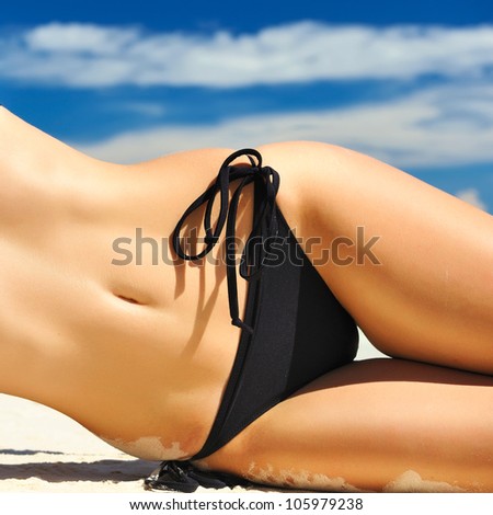 Woman with  beautiful body on a tropical beach