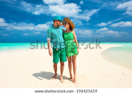 Couple in green on a tropical beach at Maldives