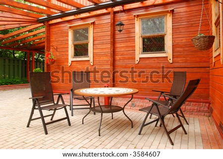 Patio furniture in front of rural house
