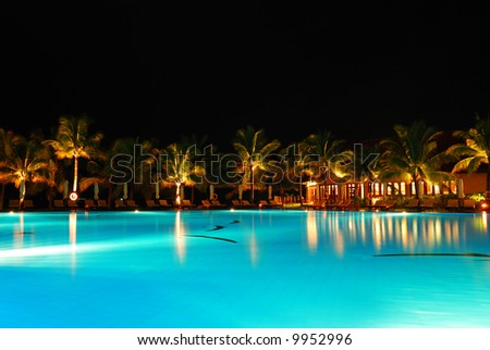 Tropical pool in luxury hotel at night