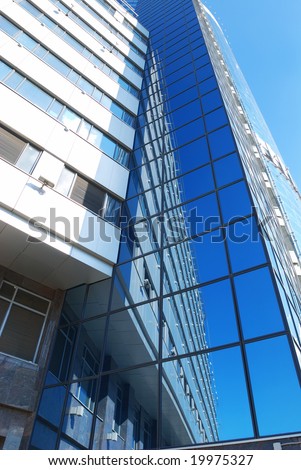 Modern office building with sky reflection in windows