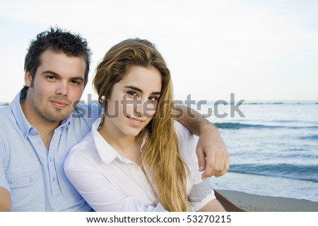 smiling young couple in love facing the camera