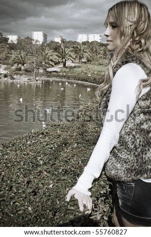 Elegant woman looking at the duck pond