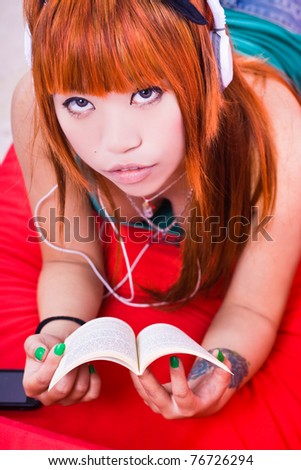 Japanese girl listening to music with headphones