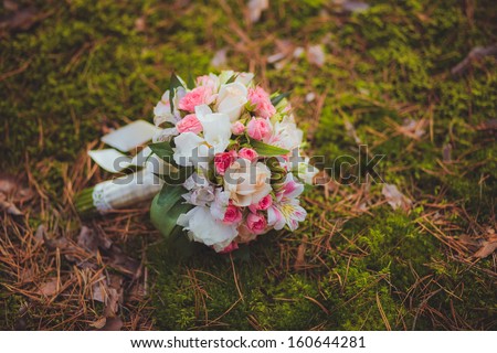 Wedding bouquet on the background of wood grass
