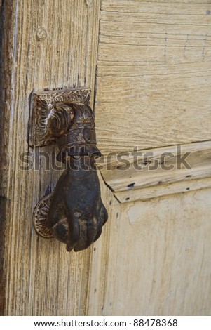 Closeup of wooden door and iron hand knob