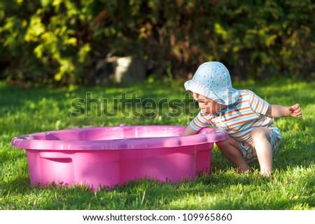 Child plays in sandpit on the playground