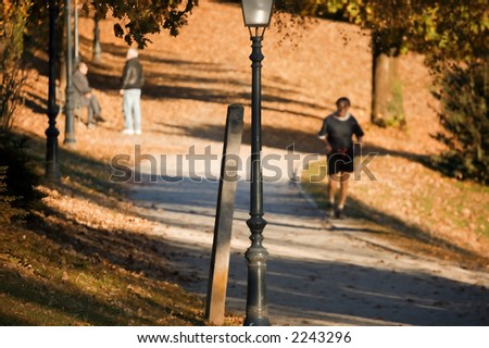 Active senior jogging in the park on a warm autumn morning