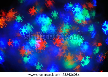 Christmas Sparkles; a set of blurred multicolored lights in snow flakes shape
