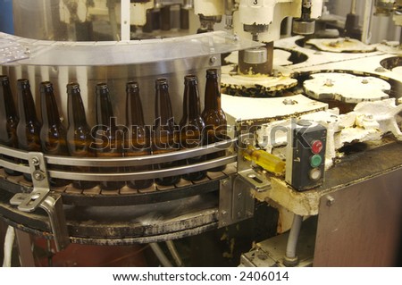 A root beer factory bottle filling line getting ready to fill bottles.