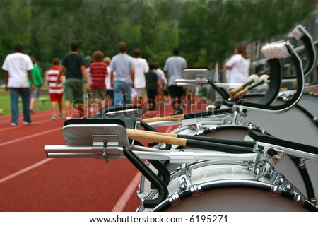 A marching band practices on the high school track before a parade