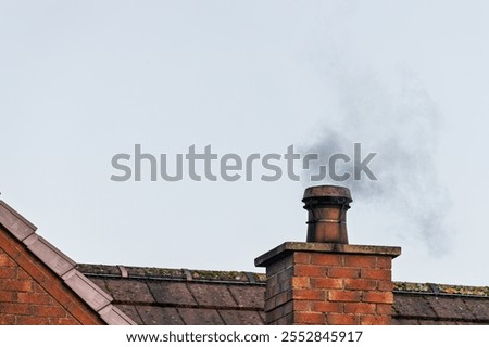 Similar – Foto Bild Ein Schornstein ragt aus dem dunklen Wohngebiet in den blutroten Himmel