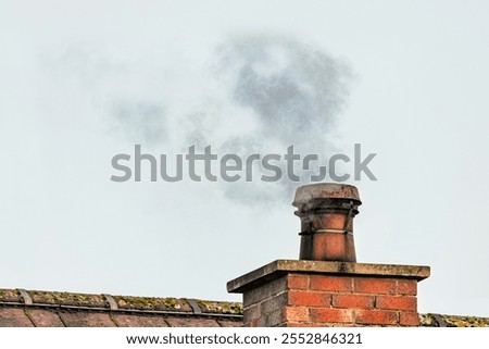 Similar – Foto Bild Ein Schornstein ragt aus dem dunklen Wohngebiet in den blutroten Himmel