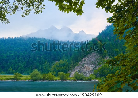 Foggy morning by The Dunajec River Gorge in The Pieniny Mountains. Nature reserve. The Three Crowns Massif view from Slovakia.