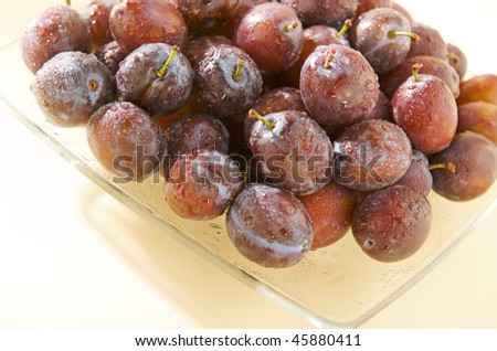 wet plums on a plate