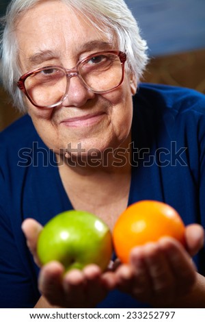 Elderly woman with fruits. Healthy diet and nutrition.