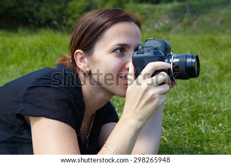 Woman photographer and reflex camera. Beautiful young photographer