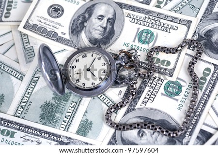 Silver clock with a watch-chain and dollars
