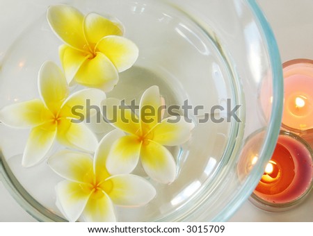 spa image of frangipani flowers and candles