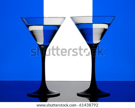 Two cocktails on a blue, white and blue background
