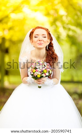 Beautiful redhead bride and wedding kiss