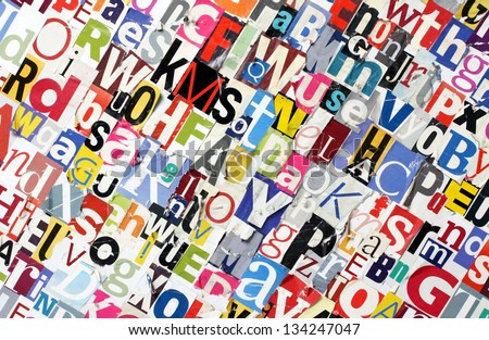 A background made from multicolored, cut ut magazine letters pasted to a board with random letters distressed and torn or stained with liquid for a dirty grunge effect.