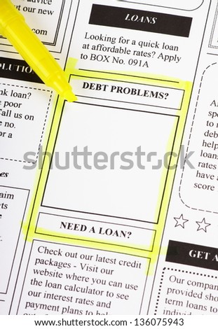 A newspaper clipping from the classified adverts section with a highlighted section around debt problems as a concept for personal finance difficulties and solutions