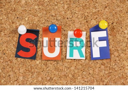 The word Surf in cut out magazine letters pinned to a cork notice board