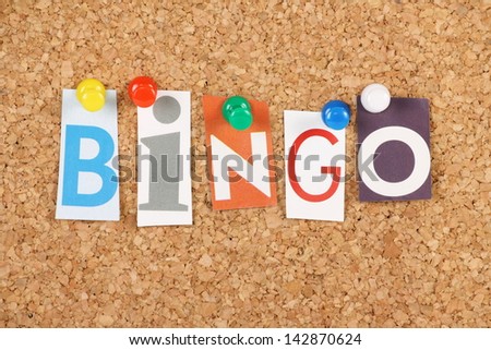 The word Bingo in cut out magazine letters pinned to a cork notice board. Bingo is a gambling game and the word is used to announce a full house or for someone providing a solution or answer