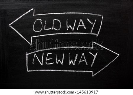 Old Way, New Way written on a blackboard with arrows pointing in the direction of the past and the future. A concept for adapting to change, improvement and development for the self or the business