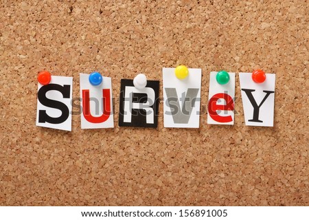 The word Survey in cut out magazine letters pinned to a cork notice board. Surveys are essential for feedback in politics and business.