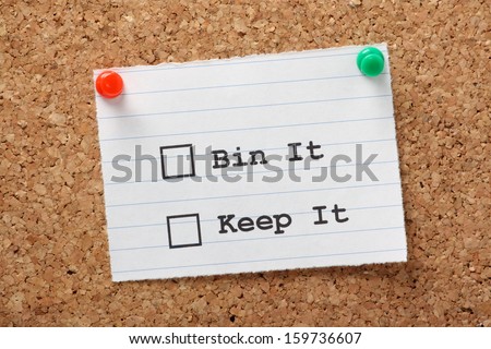 Bin it or Keep it note on a cork notice board. The decision to move forward with an idea, product or strategy and whether to discard it and move on.