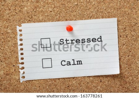Stressed or Calm Tick Boxes on a paper note pinned to a cork notice board.