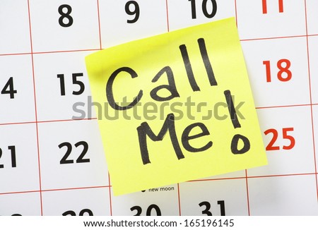 Call Me with an exclamation mark written by hand on a yellow sticky paper note and stuck to a wall calendar background.