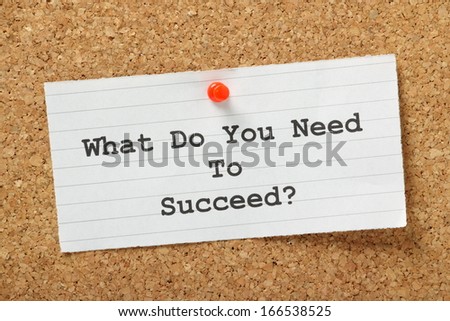 The question What Do You Need to Succeed? typed on a piece of lined paper and pinned to a cork notice board.