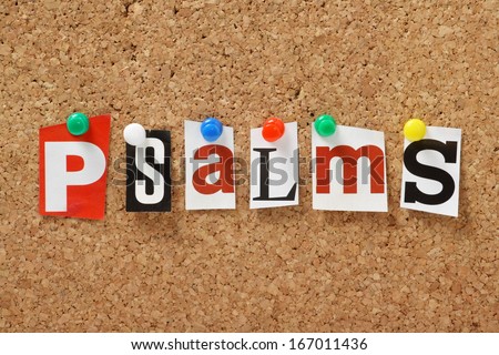 The word Psalms, one of the books from the bible in cut out out magazine letters pinned to a cork notice board
